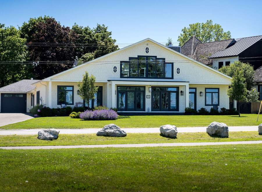Experience modern coastal living in this stunning home featuring a bright, open-concept living space with large windows and a second-story balcony perfect for enjoying the fresh air.