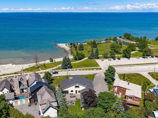 Experience coastal living at its finest with this stunning property offering direct access to a beautiful beach and panoramic views of the azure water.