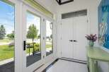 Step into this inviting entryway featuring elegant double doors that open to a bright and airy space.