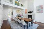 Experience elegant dining in this spacious room, featuring a rustic wooden table surrounded by comfortable upholstered chairs.