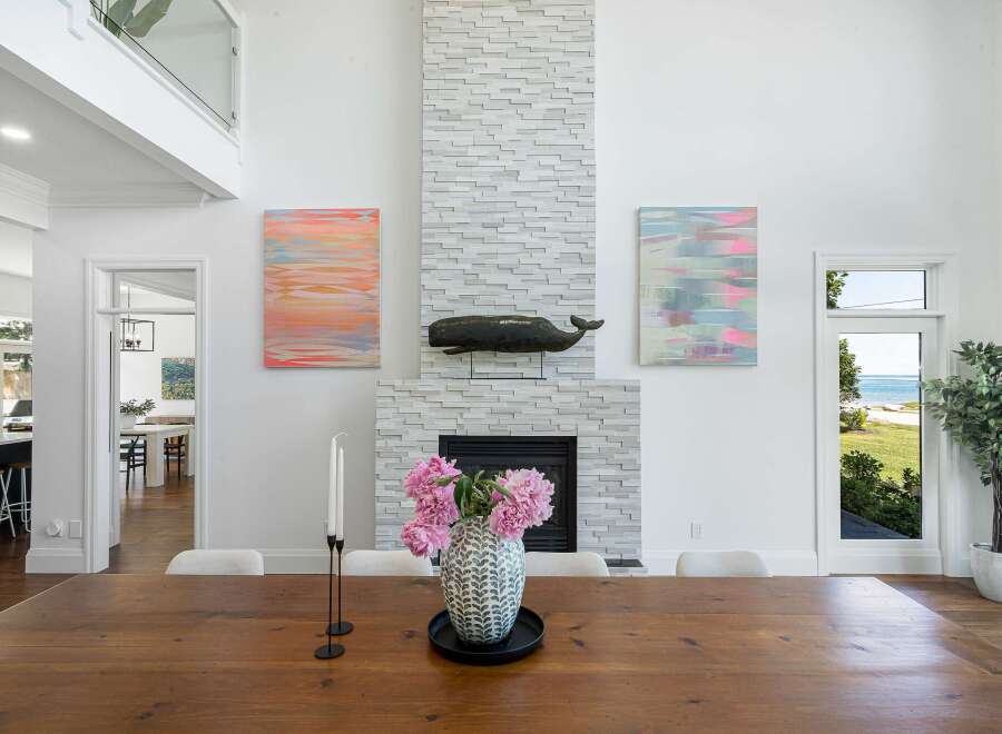 Experience coastal living in this stunning home featuring a dramatic floor-to-ceiling stacked stone fireplace as the centerpiece of the living area.
