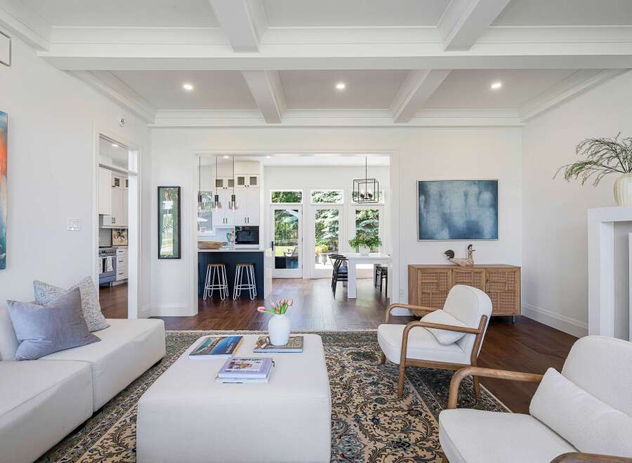 Experience modern living in this beautifully appointed open-concept home, featuring a spacious living area that seamlessly flows into a gourmet kitchen and dining space.