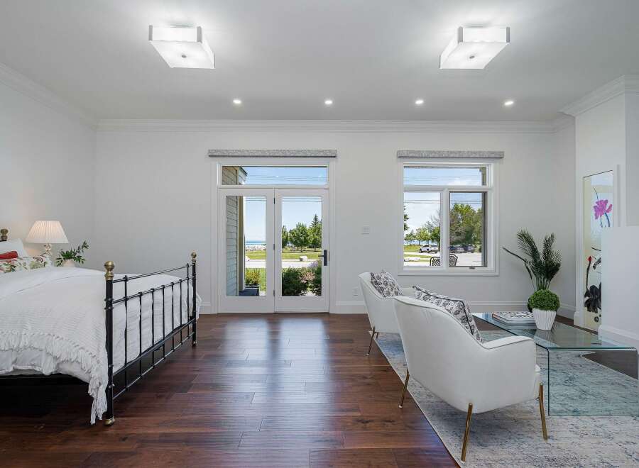 Experience coastal living in this beautifully appointed bedroom featuring a comfortable queen-size bed and elegant seating area.