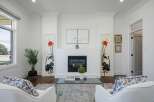 Experience elegant living in this beautifully appointed living room, featuring a modern fireplace as the focal point.