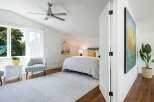 This bright and airy bedroom features a vaulted ceiling with a modern ceiling fan, perfect for year-round comfort.