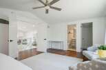 Step into this beautifully appointed bedroom, featuring a modern ceiling fan and a stylish rug.