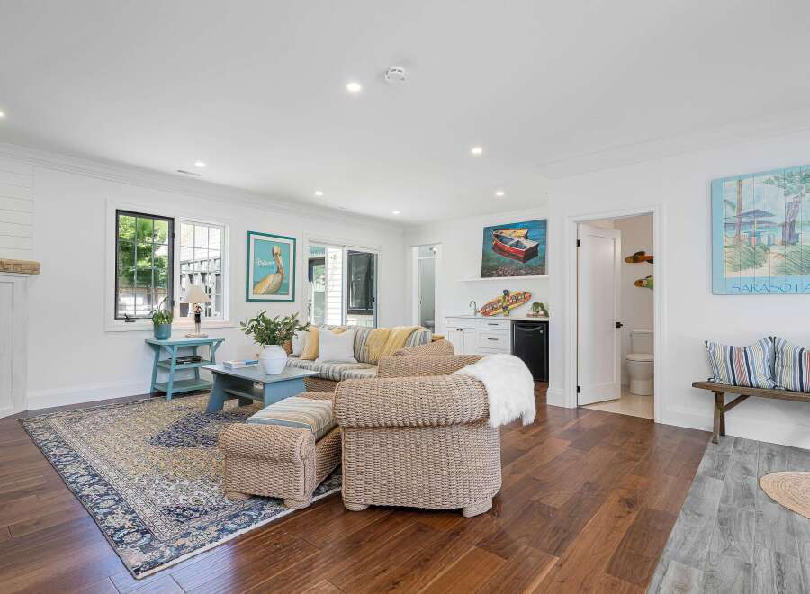 This inviting living room features a cozy sectional sofa adorned with striped pillows and throws, perfect for relaxing.
