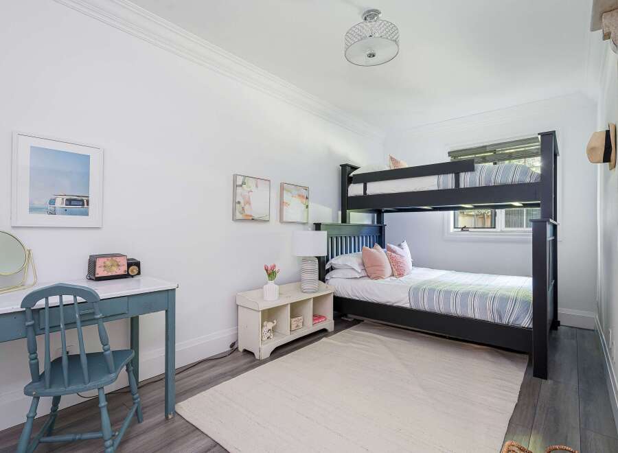 This charming bedroom features a space-saving bunk bed, perfect for families or guests.