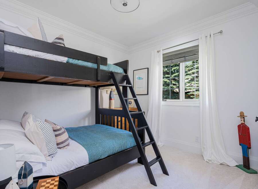 This charming bedroom features a space-saving bunk bed, perfect for accommodating guests or children.
