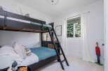 This charming bedroom features a space-saving bunk bed, perfect for accommodating guests or children.