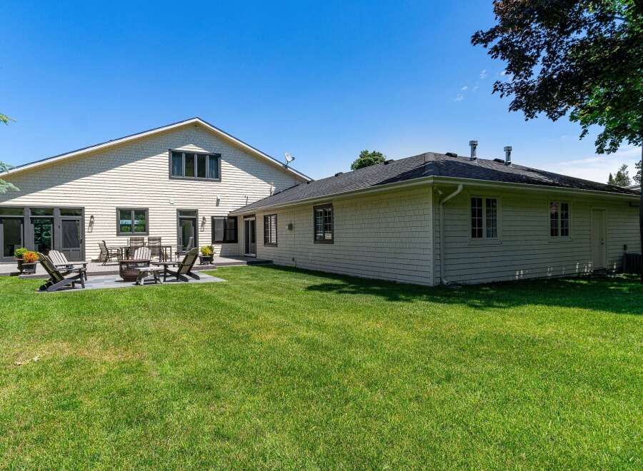 Enjoy outdoor living in this spacious backyard featuring a large deck and patio area perfect for entertaining.