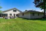 Enjoy outdoor living in this spacious backyard featuring a large deck and patio area perfect for entertaining.