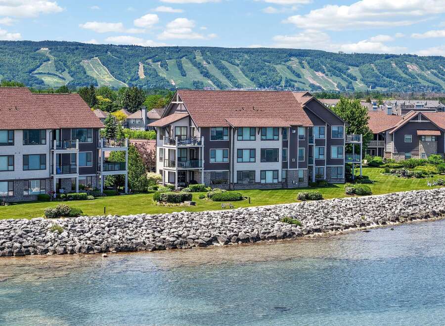 Experience luxury waterfront living with these stunning condo units offering breathtaking views of the lake and the majestic ski hills in the distance.