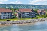 Experience luxury waterfront living with these stunning condo units offering breathtaking views of the lake and the majestic ski hills in the distance.