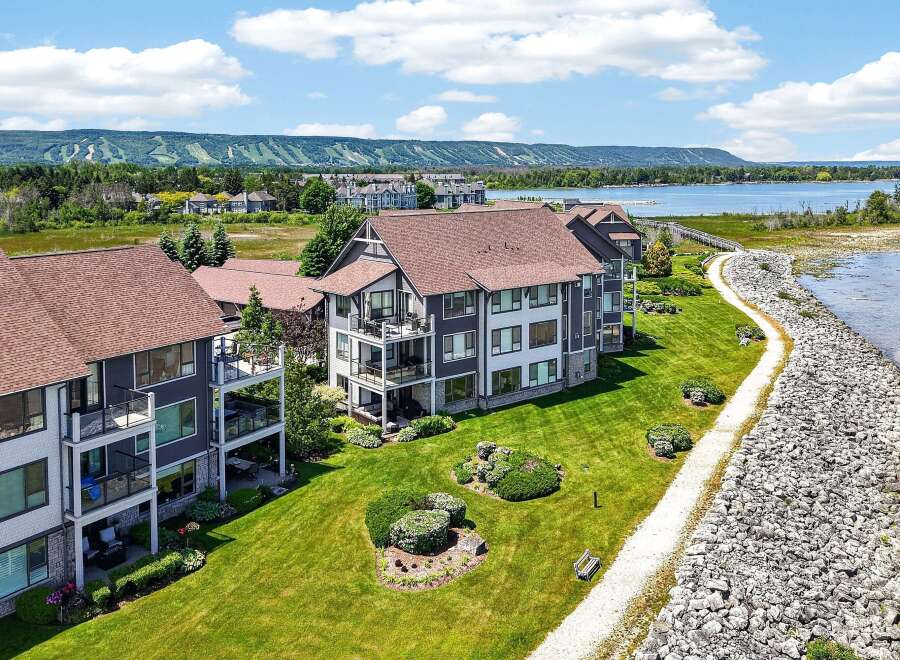 Experience luxury living with stunning lake views and mountain vistas from this modern condominium complex.