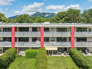 Discover modern living in this multi-story apartment building, featuring spacious balconies with glass railings and awnings for comfortable outdoor enjoyment.