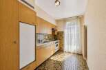 This charming kitchen features warm wooden cabinetry and a practical layout, perfect for everyday use.