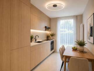 Discover this modern kitchen and dining area, featuring sleek, light wood cabinetry and integrated appliances.