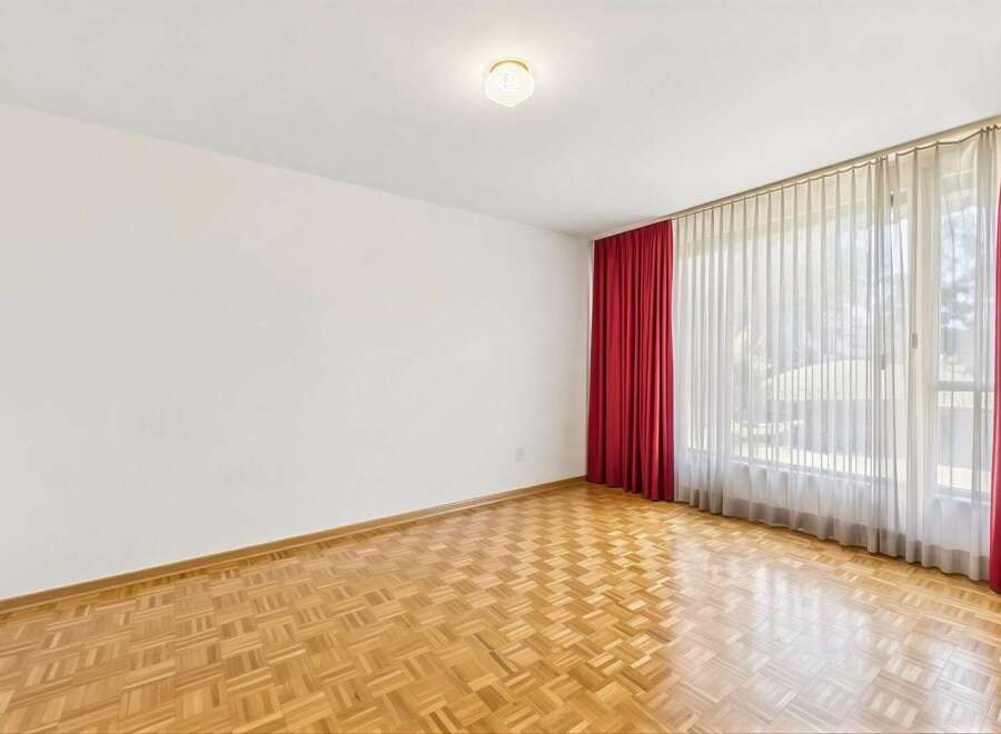 This spacious room features beautiful parquet flooring that adds warmth and character.