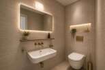 Experience modern luxury in this beautifully designed bathroom, featuring a sleek wall-mounted sink and a minimalist toilet.