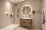 Experience modern luxury in this stunning bathroom featuring a spacious walk-in shower with elegant tilework and a built-in niche for toiletries.