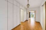 Step into this inviting hallway featuring a beautiful parquet floor and ample built-in storage.