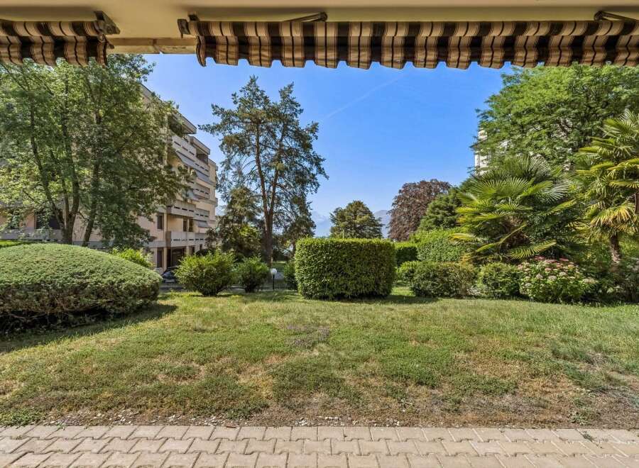 Enjoy the lush greenery and serene ambiance from this property's vantage point, overlooking a beautifully manicured garden.