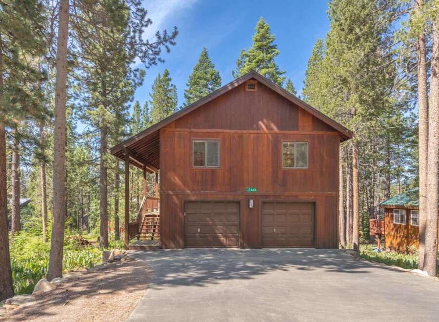 Nestled among tall pine trees, this charming wooden home offers a serene mountain retreat.