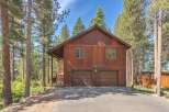 Nestled among tall pine trees, this charming wooden home offers a serene mountain retreat.