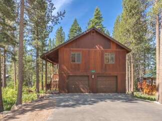 Nestled among tall pine trees, this charming wooden home offers a serene mountain retreat.