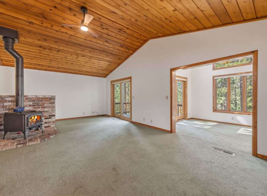 Cozy living room featuring a rustic brick fireplace with a wood-burning stove, perfect for chilly evenings.