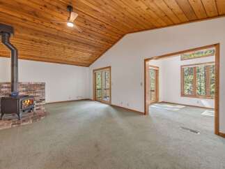 Cozy living room featuring a rustic brick fireplace with a wood-burning stove, perfect for chilly evenings.