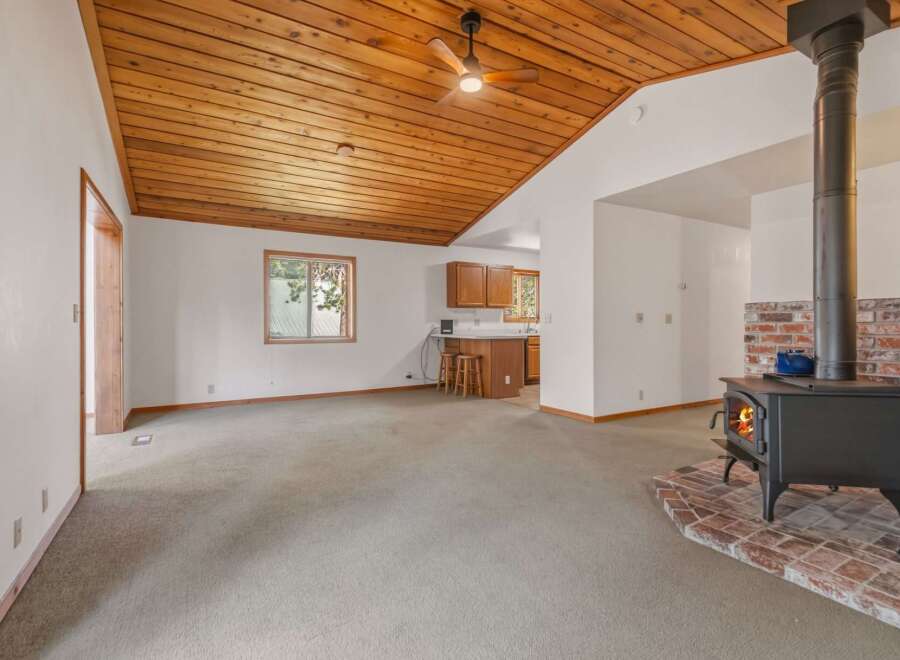 Cozy living room featuring a wood-burning stove with a brick hearth, perfect for chilly evenings.