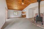 Cozy living room featuring a wood-burning stove with a brick hearth, perfect for chilly evenings.