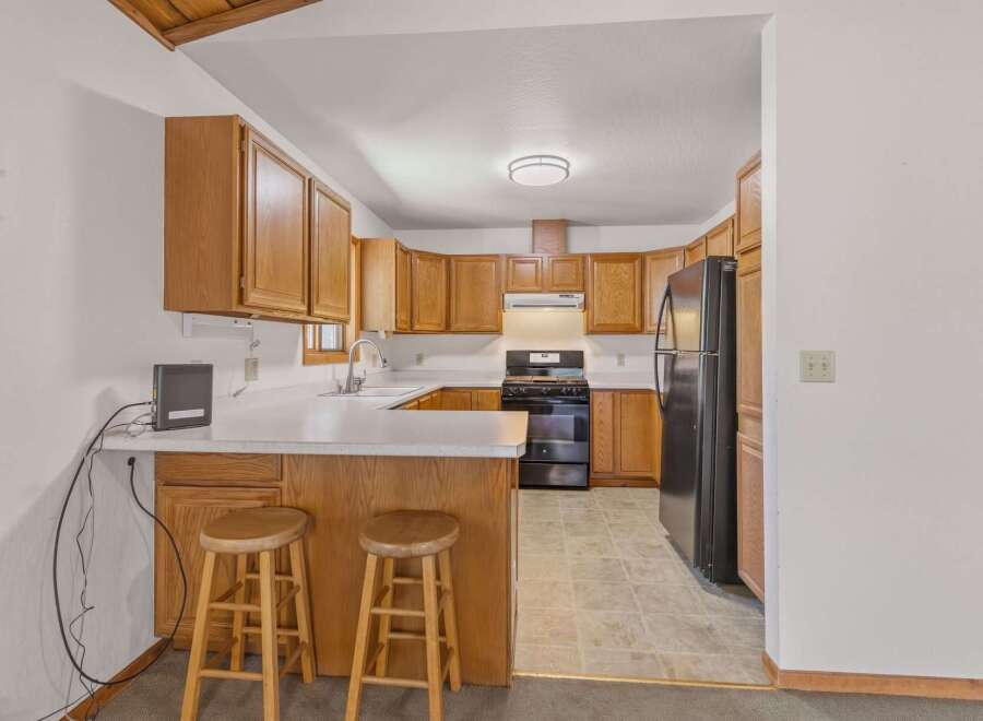 Discover this charming kitchen featuring warm wooden cabinetry and a functional layout perfect for everyday cooking.