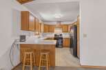 Discover this charming kitchen featuring warm wooden cabinetry and a functional layout perfect for everyday cooking.