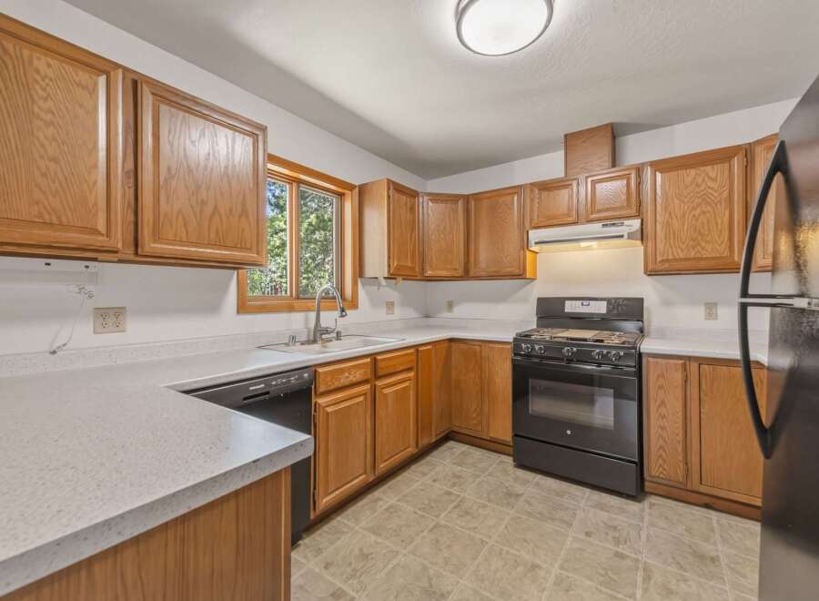 This kitchen features warm, honey-toned wood cabinetry that offers ample storage space.