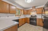 This kitchen features warm, honey-toned wood cabinetry that offers ample storage space.