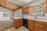 Step into this charming kitchen featuring warm wooden cabinetry and a spacious double sink, perfect for meal preparation.