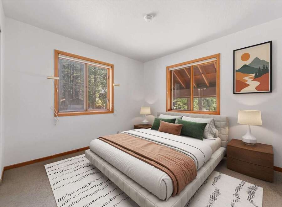 This cozy bedroom features a comfortable queen-size bed with plush pillows and a warm throw blanket, perfect for relaxation.