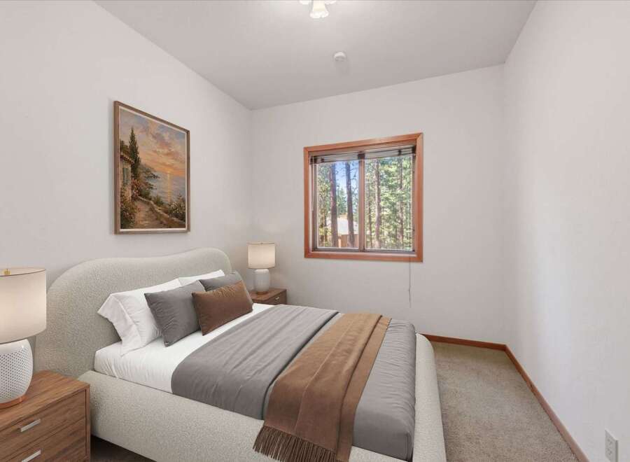 This cozy bedroom features a plush bed with soft linens and decorative pillows, perfect for a restful night's sleep.