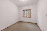 This cozy room features a large window offering picturesque views of the surrounding forest.