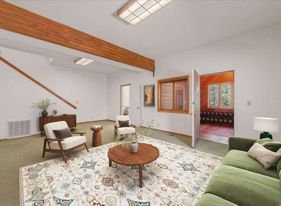 Step into this inviting living room featuring a large, ornate rug that anchors the space.