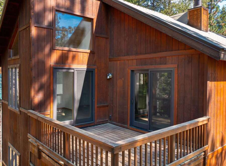 Experience the charm of this rustic wooden cabin, featuring a spacious deck perfect for enjoying the surrounding nature.
