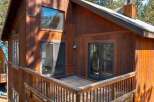 Experience the charm of this rustic wooden cabin, featuring a spacious deck perfect for enjoying the surrounding nature.