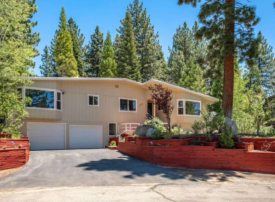 Nestled among tall pine trees, this charming home offers a serene mountain retreat.