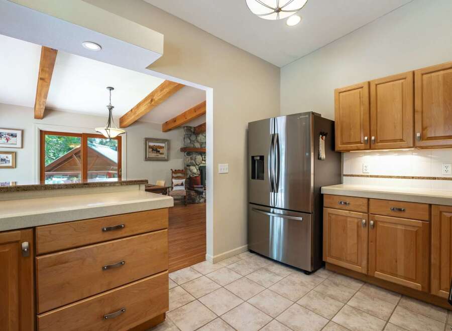 Discover a charming kitchen featuring a stainless steel Samsung refrigerator and ample natural light.
