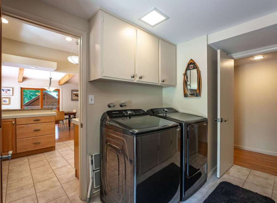Discover the convenience of this well-appointed laundry room, featuring modern Samsung washer and dryer units.