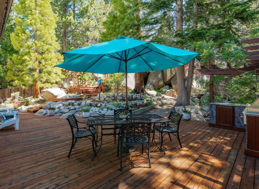 Enjoy outdoor living on this spacious wooden deck, perfect for entertaining or relaxing.