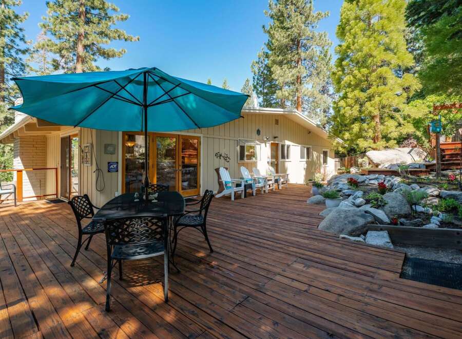 Enjoy outdoor living on this expansive wooden deck, perfect for entertaining or relaxing.
